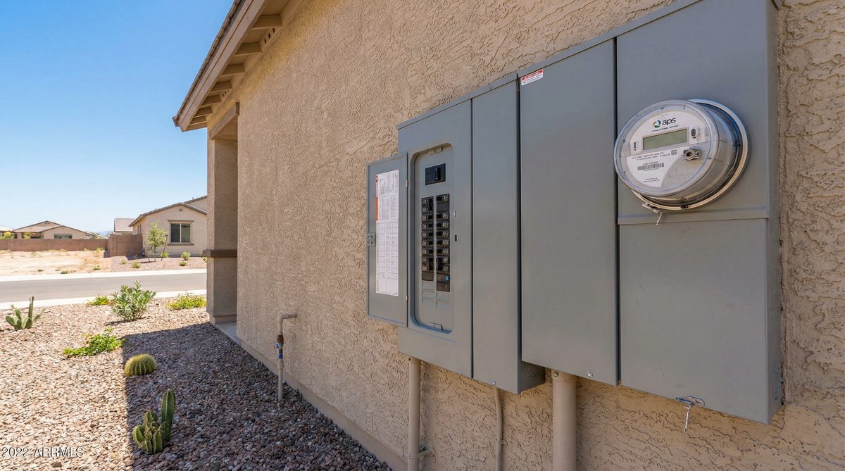 APS electrical meter and breaker panel on exterior of new Goodyear Arizona stucco home