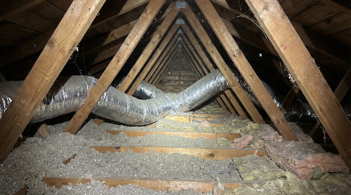 Residential attic showing HVAC flex ductwork and insulation